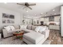 Open living space featuring a large sofa, wood floors, and plenty of natural light at 2371 W Whisper Rock Trl, Phoenix, AZ 85085