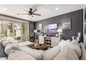 Comfortable living room with a cozy sectional sofa, entertainment center, and sliding glass doors at 2371 W Whisper Rock Trl, Phoenix, AZ 85085