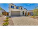 Charming home featuring a paved driveway, an attached two-car garage, and desert landscaping at 24533 N 19Th Ter, Phoenix, AZ 85024