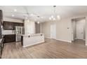 Bright kitchen featuring stainless appliances, granite counters, and a breakfast bar island at 28263 N Welton Pl, San Tan Valley, AZ 85143