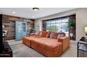 Comfortable living room with stylish wood accent wall, large sectional sofa, and bright natural light at 3007 N 84Th Pl, Scottsdale, AZ 85251