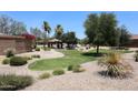 Beautifully landscaped community park with lush green grass, walking paths, mature trees, and a covered picnic area at 3545 W Glass Ln, Phoenix, AZ 85041