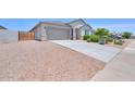 Charming home featuring a spacious two-car garage, desert landscaping, and a well-maintained front yard at 38144 W San Clemente St, Maricopa, AZ 85138