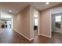 Hallway with wood-look tile flooring, leading to a bathroom, bedroom, and sliding glass doors at 38144 W San Clemente St, Maricopa, AZ 85138