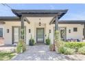 Inviting home featuring a covered front entrance with a grey walkway and vibrant landscaping at 3924 E Roma Ave, Phoenix, AZ 85018