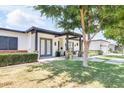 Charming home featuring a covered front entrance, manicured landscaping, and a lush green lawn at 3924 E Roma Ave, Phoenix, AZ 85018