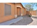 A well-maintained front entrance with a secure screen door and a tidy, desert-style garden at 40468 W Sanders Way, Maricopa, AZ 85138