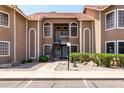 Two-story condo building with desert landscaping, a red tile roof, and private entry stairs at 5230 E Brown Rd # 114, Mesa, AZ 85205