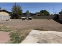 Large backyard featuring desert landscaping with trailers stored behind a concrete block wall at 608 W 2Nd Pl, Mesa, AZ 85201