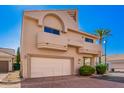 Desert home showcasing a two-story facade, two car garage, and a well-manicured yard under a clear sky at 6510 S Hazelton Ln # 101, Tempe, AZ 85283