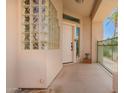 Inviting front porch with a unique glass block wall and a view of a palm tree at 6510 S Hazelton Ln # 101, Tempe, AZ 85283
