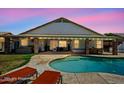 Inviting backyard features a covered patio, built-in bbq, swimming pool, and lounge chairs for relaxing at 6935 W Monte Lindo St, Glendale, AZ 85310