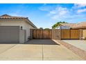 Spacious driveway featuring both an RV gate and a two-car garage, offering ample parking at 6935 W Monte Lindo St, Glendale, AZ 85310