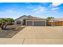 Beautiful stucco home features a tile roof, desert landscaping, and a spacious two-car garage at 6935 W Monte Lindo St, Glendale, AZ 85310