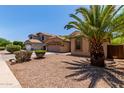 A well-manicured lawn and desert landscaping frame this charming home in a desirable neighborhood at 7169 W Lamar Rd, Glendale, AZ 85303