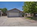 Charming single-story home featuring a spacious two-car garage and a well-maintained front yard with mature landscaping at 807 E San Remo Ave, Gilbert, AZ 85234