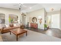 Inviting living room featuring high ceilings, slate floors, a patterned rug, and neutral paint at 9623 S 25Th Ln, Phoenix, AZ 85041