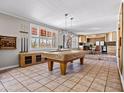 Spacious game room includes a pool table, bar area, and great natural light at 1 W Canterbury Ln, Phoenix, AZ 85023