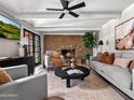This second view of the living room shows a fireplace and access to the pool at 1 W Canterbury Ln, Phoenix, AZ 85023