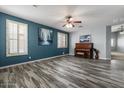 Spacious living room with plank flooring, large windows, and stylish décor at 10235 E Jerome Ave, Mesa, AZ 85209