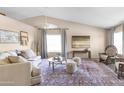 Bright living room with vaulted ceilings, plush seating, and natural light at 10702 W Orangewood Ave, Glendale, AZ 85307