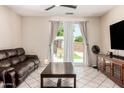 Bright living room with a sliding door to the backyard, comfortable seating, and an entertainment center at 11206 W Coronado Rd, Avondale, AZ 85392