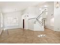 Bright living room features soaring ceilings, neutral paint, and a staircase leading to the second floor at 1216 E Rocky Slope Dr, Phoenix, AZ 85048