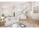 Bright living room featuring soaring ceilings, neutral paint, and a staircase leading to the second floor at 1216 E Rocky Slope Dr, Phoenix, AZ 85048