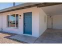 Close up view of the entrance featuring a blue door and a covered carport at 1466 E Nielson Ave, Mesa, AZ 85204