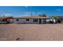 Single story home featuring a low pitched roof and a gravel yard at 1466 E Nielson Ave, Mesa, AZ 85204