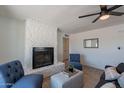 Charming living room with a decorative stone fireplace and stylish, comfortable seating at 1466 E Nielson Ave, Mesa, AZ 85204