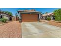 A charming single-story home with a spacious two-car garage and desert landscaping at 14936 W Maui Ln, Surprise, AZ 85379