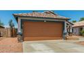 Single-Gathering home featuring a two-car garage, desert landscaping, and a cozy exterior at 14936 W Maui Ln, Surprise, AZ 85379