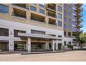 Exterior shot of a modern apartment building entrance with well-maintained landscaping and signage at 15215 N Kierland Blvd # 101, Scottsdale, AZ 85254