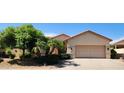 Charming single-story home featuring a two-car garage and meticulously landscaped front yard at 15728 W Verde Ln, Goodyear, AZ 85395
