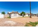 Modest single story home with a front yard, desert landscape, and stucco walls at 1602 N 73Rd Dr, Phoenix, AZ 85035