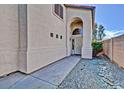 Inviting front entry featuring an arched entryway and well-maintained landscaping at 16029 W Ocotillo Ln, Surprise, AZ 85374