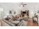 Cozy living room with vaulted ceilings, neutral paint, ceiling fan, and tile floors at 19546 N 53Rd Ave, Glendale, AZ 85308