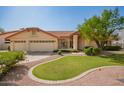 Charming home with a three-car garage, lush lawn, mature trees, and desert landscaping at 1956 E Calle De Caballos --, Tempe, AZ 85284