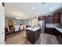 Open-concept kitchen features stainless steel appliances and overlooks the dining and living areas at 20545 W Terrace Ln, Buckeye, AZ 85396