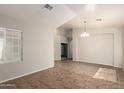 Bright, tiled living room featuring arched doorways, neutral paint, and ample natural light at 20895 E Via Del Rancho Rd, Queen Creek, AZ 85142