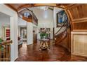 Elegant foyer showcasing wood floors, a staircase, second story overlook and a crystal chandelier at 211 W Kaler Dr, Phoenix, AZ 85021