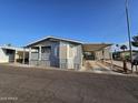 Well-kept home exterior with a large covered parking area and vibrant landscaping, showcasing curb appeal at 2121 N Center St # 131, Mesa, AZ 85201