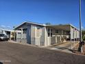 Inviting exterior of a well-maintained home with covered parking, mature trees, and manicured landscape at 2121 N Center St # 131, Mesa, AZ 85201