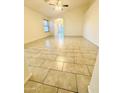 This living room boasts tiled floors, recessed lighting, and plentiful natural light through a window at 22951 W Loma Linda Blvd, Buckeye, AZ 85326