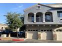 Stylish two-story townhome with a balcony, three garages, and a neutral color palette, adding architectural interest at 2402 E 5Th St # 1472, Tempe, AZ 85288