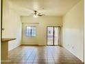 Spacious living room features a ceiling fan, and sliding door offering access to a balcony with views at 2402 E 5Th St # 1472, Tempe, AZ 85288