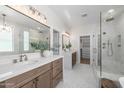 Elegant bathroom featuring double sinks, a glass shower, and walk-in closet at 2743 E Virginia St, Gilbert, AZ 85296