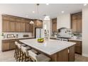 Spacious kitchen with marble countertops, an island with seating and modern fixtures at 2743 E Virginia St, Gilbert, AZ 85296