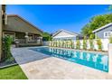 Backyard featuring a sparkling pool with stone patio and well-maintained landscaping at 2743 E Virginia St, Gilbert, AZ 85296